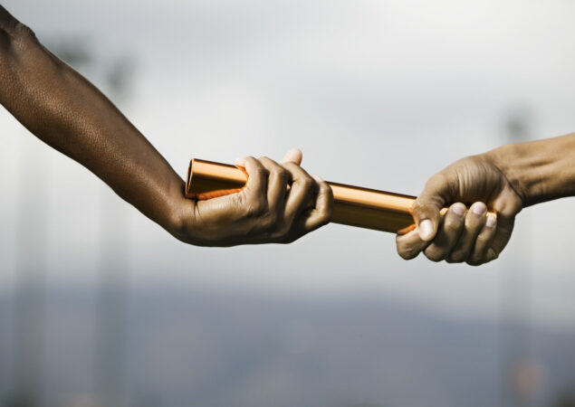 hands passing a baton